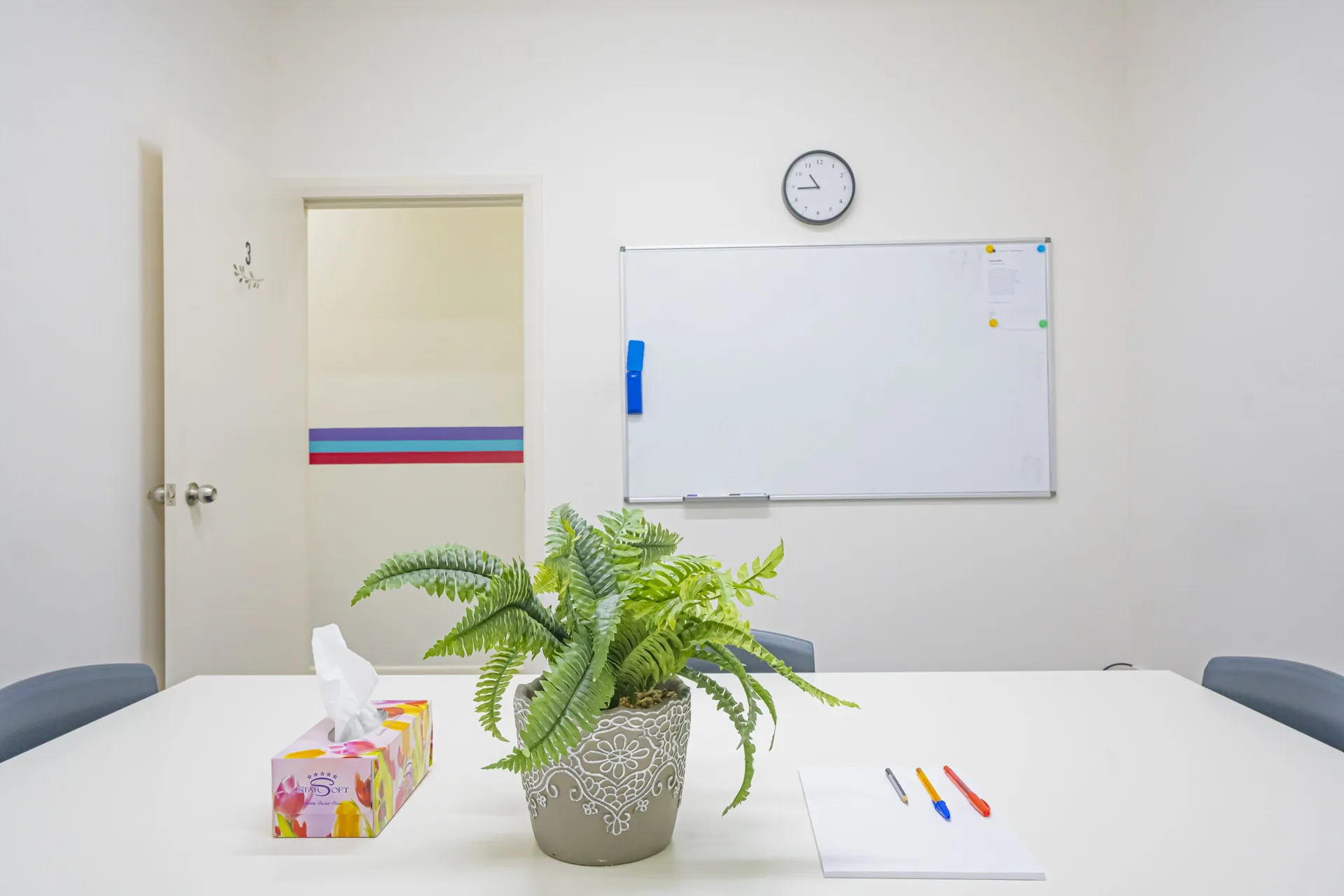 A small-group classroom at Smart Space Tutoring with a whiteboard and plants