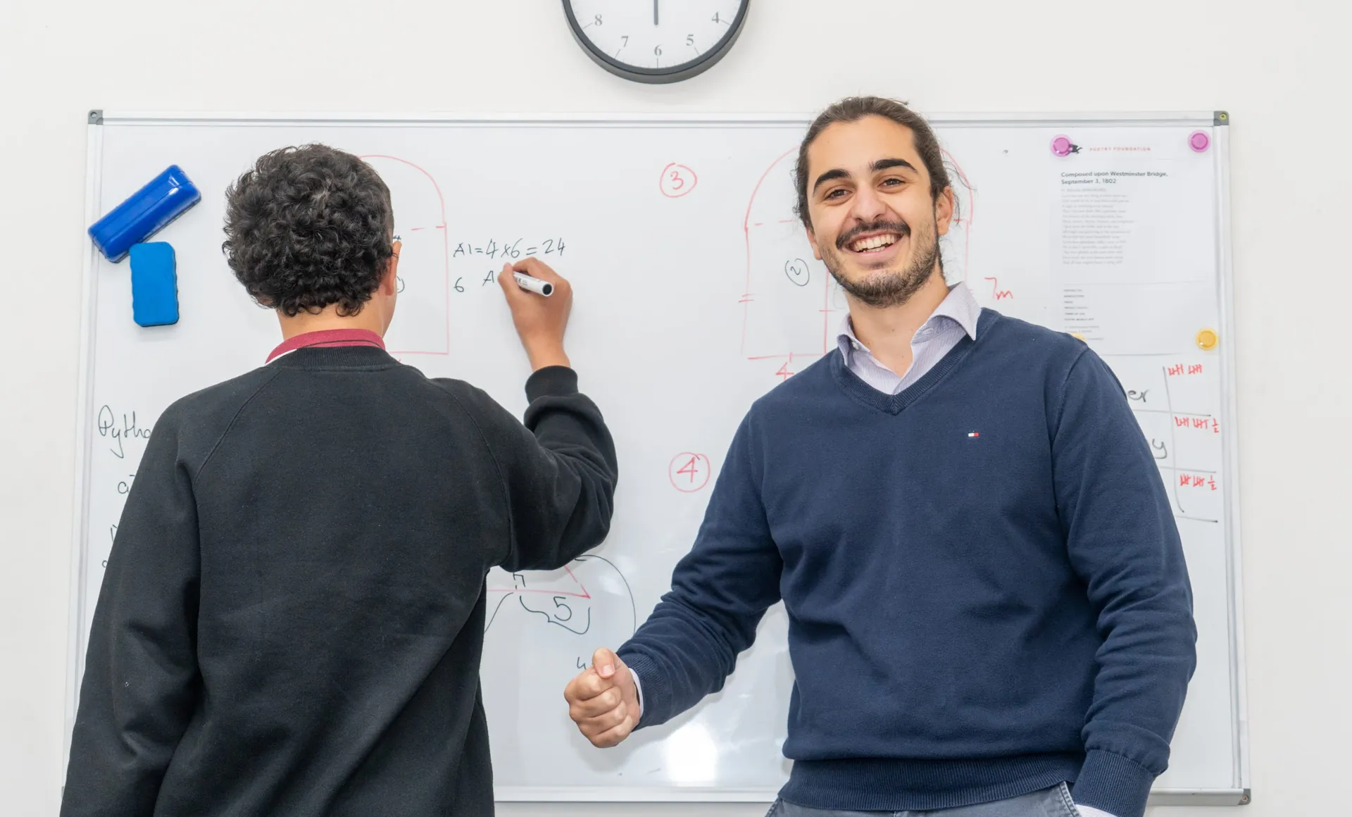 A Smart Space tutor working through a problem at the whiteboard with a student