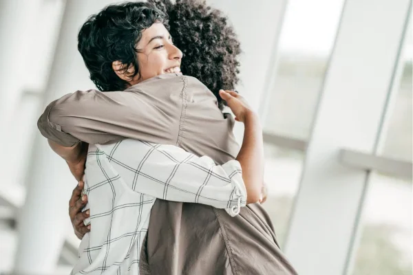 Two people embracing in a warm hug